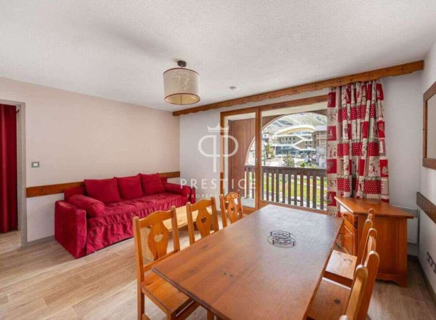 Discover a cozy living space with a vibrant red sofa, perfect for relaxation.