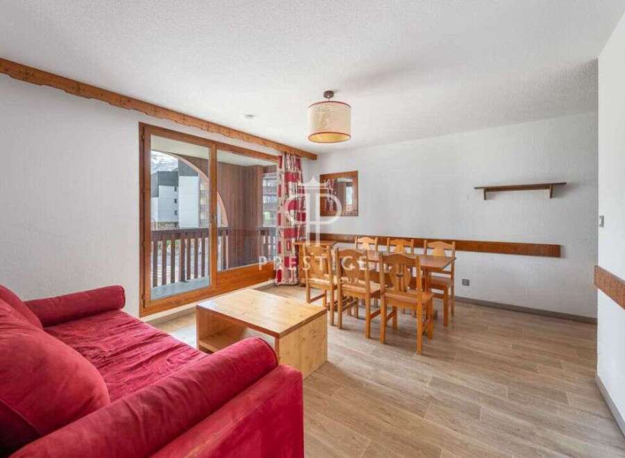 Discover a cozy living space with a vibrant red sofa, perfect for relaxation.