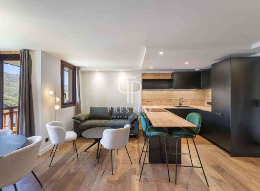 Discover a stunning property with a modern kitchen featuring sleek black cabinetry and a stylish breakfast bar.