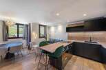 Discover a stunning property with a modern kitchen featuring sleek black cabinetry and a wooden countertop.