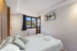 Experience luxury in this stunning property, featuring a cozy bedroom with a comfortable bed and stylish pillows.