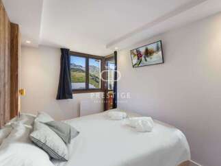 Experience luxury in this stunning property, featuring a cozy bedroom with a comfortable bed and stylish pillows.