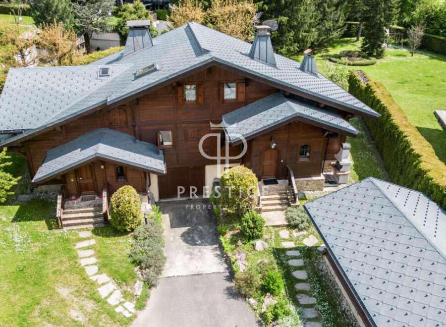 Discover a stunning property with a charming wooden exterior and a beautifully designed roof.