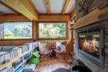 Experience cozy luxury in this stunning chalet, featuring a warm fireplace and inviting seating area.