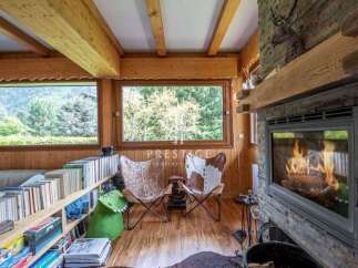 Experience cozy luxury in this stunning chalet, featuring a warm fireplace and inviting seating area.