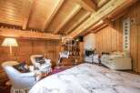 Discover the charm of this cozy bedroom featuring a stunning wooden ceiling and walls, creating a warm and inviting atmosphere.