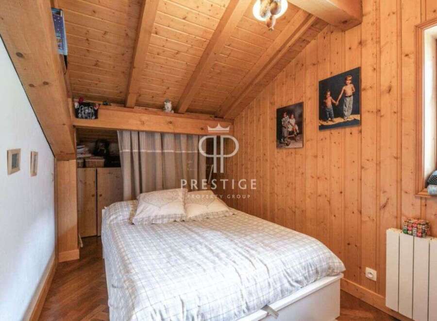 Charming bedroom with a cozy wooden interior.