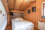 Charming bedroom with a cozy wooden interior.