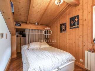 Charming bedroom with a cozy wooden interior.