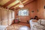 Cozy wooden-paneled bedroom with a charming, rustic aesthetic.