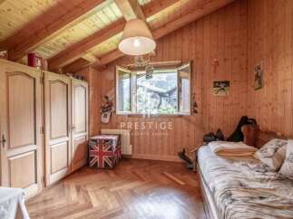 Cozy wooden-paneled bedroom with a charming, rustic aesthetic.