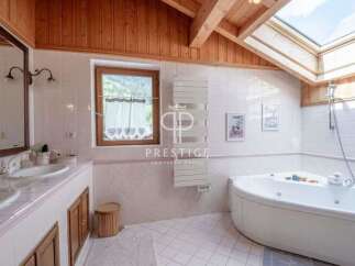 Discover a luxurious bathroom retreat with a stunning skylight and wooden accents.