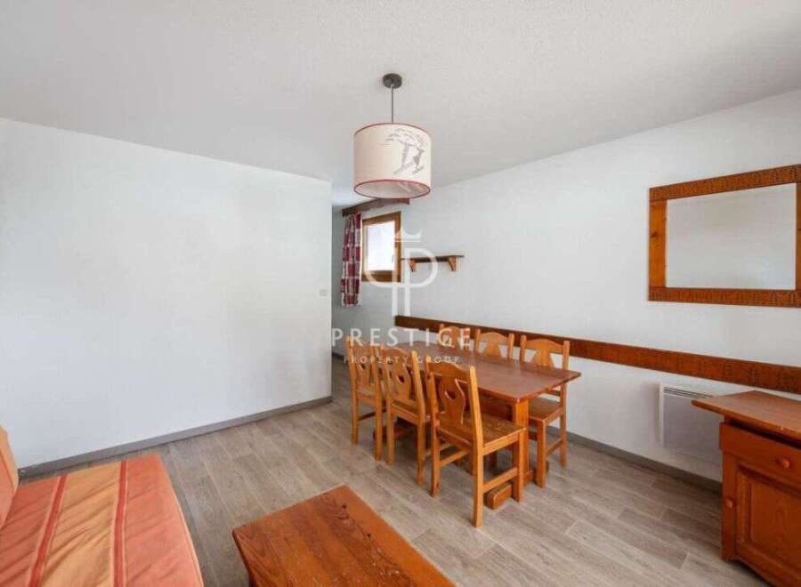 Discover a cozy dining area with a wooden table and chairs, perfect for enjoying meals.