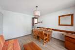 Discover a cozy dining area with a wooden table and chairs, perfect for enjoying meals.