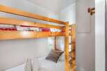 Cozy bunk beds offer a comfortable sleeping arrangement, perfect for families or groups.
