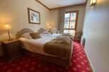 Discover a cozy bedroom featuring two comfortable beds, perfect for a relaxing stay.