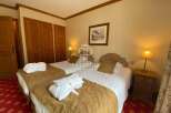 Discover a cozy bedroom featuring two comfortable beds, perfect for a relaxing stay.