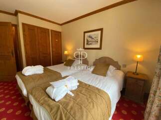 Discover a cozy bedroom featuring two comfortable beds, perfect for a relaxing stay.