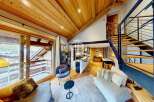 Discover the charm of this stunning property, featuring a warm wooden ceiling and a cozy living space.