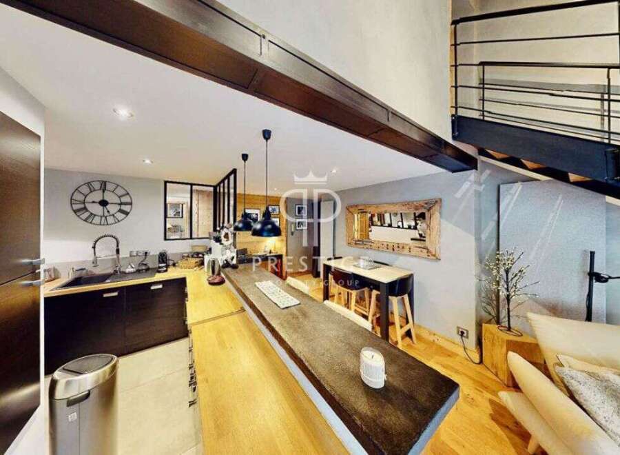 Discover modern living in this stunning property! Featuring a sleek kitchen with dark cabinetry and a spacious island, perfect for entertaining.