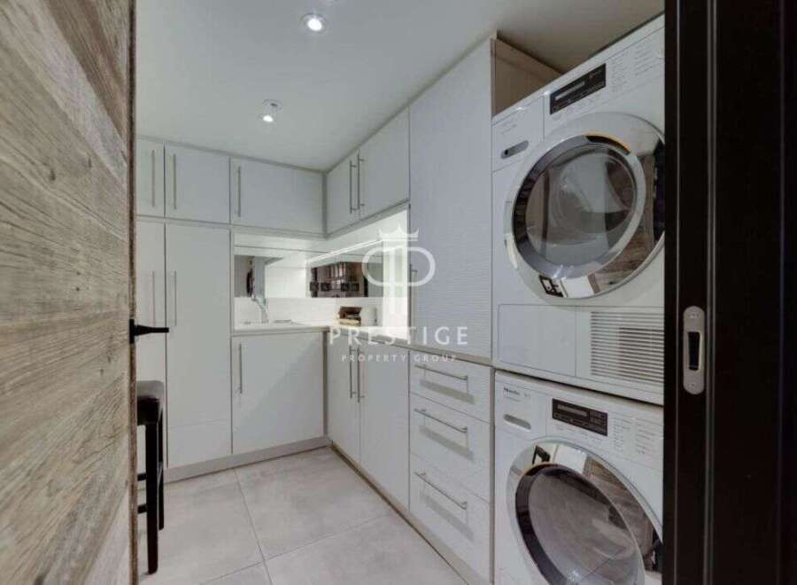 Discover modern living in this stunning property, featuring a sleek and functional laundry room.