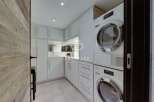 Discover modern living in this stunning property, featuring a sleek and functional laundry room.
