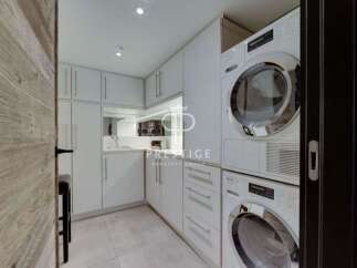 Discover modern living in this stunning property, featuring a sleek and functional laundry room.