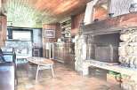 Cozy living room with a rustic fireplace, perfect for relaxing evenings.