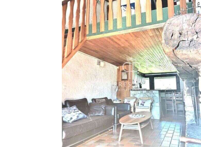 Discover the charm of this unique property, featuring a cozy living area with a comfortable sofa and stylish chairs.