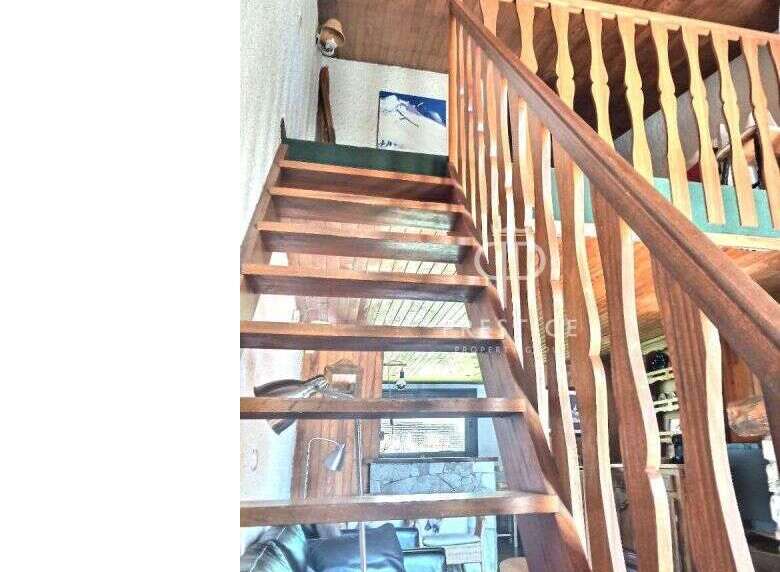 This stunning property features a beautiful wooden staircase, adding a touch of warmth and elegance to the interior.