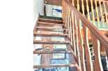 This stunning property features a beautiful wooden staircase, adding a touch of warmth and elegance to the interior.