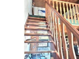 This stunning property features a beautiful wooden staircase, adding a touch of warmth and elegance to the interior.
