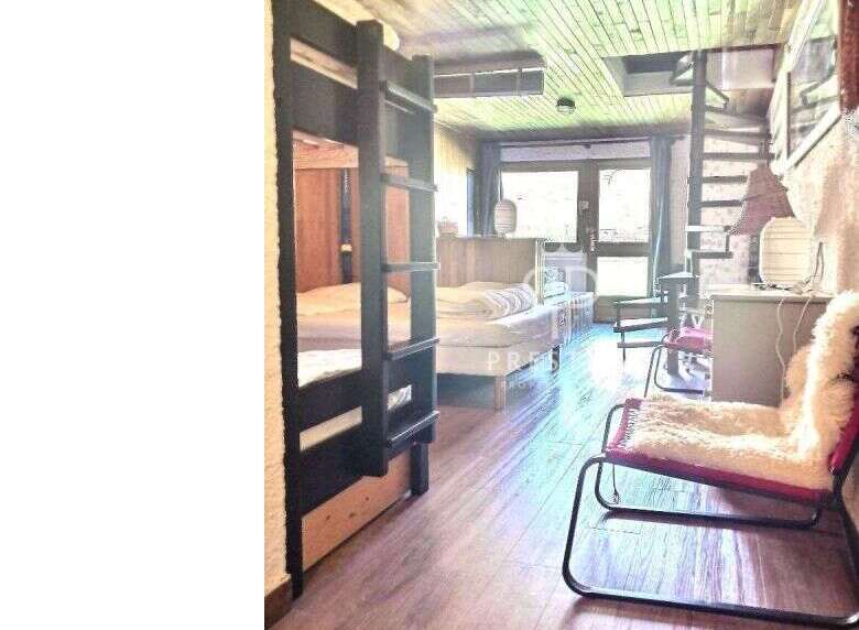 Cozy cabin living at its finest! This charming space features a unique bunk bed setup, perfect for accommodating guests or family.