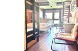 Cozy cabin living at its finest! This charming space features a unique bunk bed setup, perfect for accommodating guests or family.