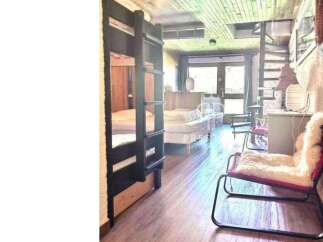 Cozy cabin living at its finest! This charming space features a unique bunk bed setup, perfect for accommodating guests or family.