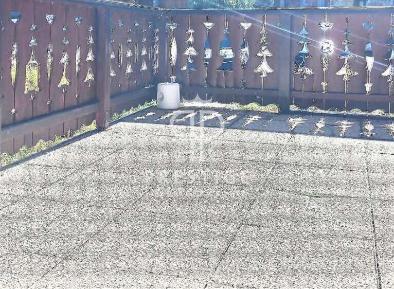 Discover a charming outdoor space with a unique wooden fence adorned with decorative cutouts.