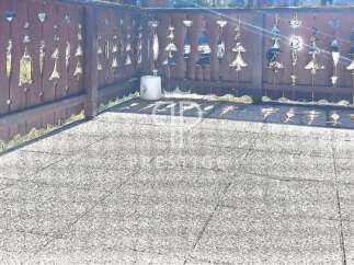 Discover a charming outdoor space with a unique wooden fence adorned with decorative cutouts.