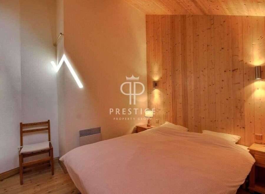 Discover the charm of this cozy bedroom, featuring a unique wooden accent wall and ceiling.