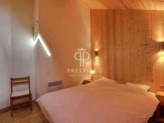 Discover the charm of this cozy bedroom, featuring a unique wooden accent wall and ceiling.