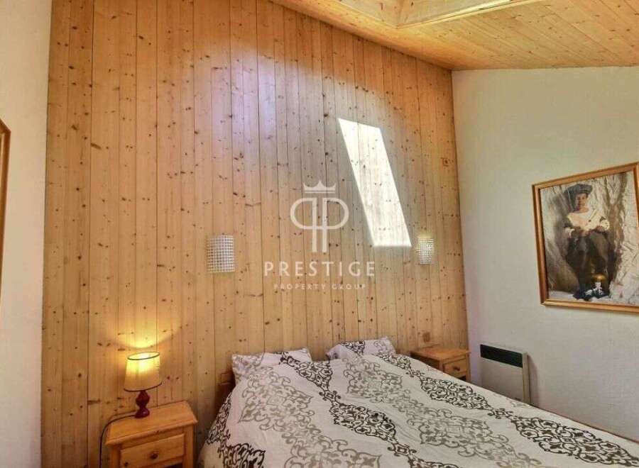 Discover the charm of this cozy bedroom featuring stunning wood paneling that adds warmth and character.