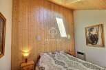 Discover the charm of this cozy bedroom featuring stunning wood paneling that adds warmth and character.