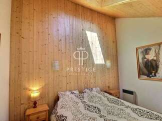 Discover the charm of this cozy bedroom featuring stunning wood paneling that adds warmth and character.