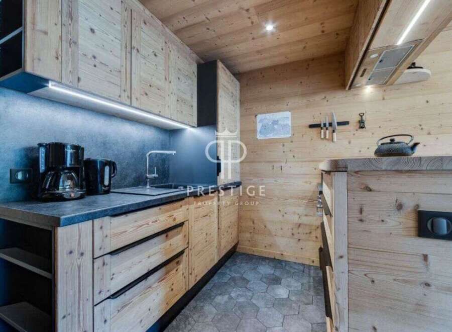 Discover the charm of this cozy kitchen, featuring beautiful wooden cabinetry and a modern design.