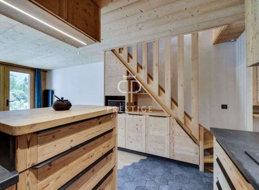 Discover the charm of this stunning property, featuring a beautifully designed wooden staircase and a modern kitchen.