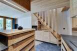 Discover the charm of this stunning property, featuring a beautifully designed wooden staircase and a modern kitchen.