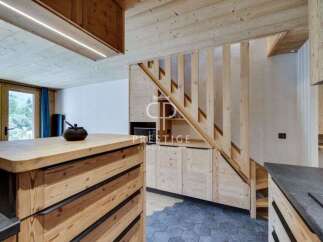 Discover the charm of this stunning property, featuring a beautifully designed wooden staircase and a modern kitchen.