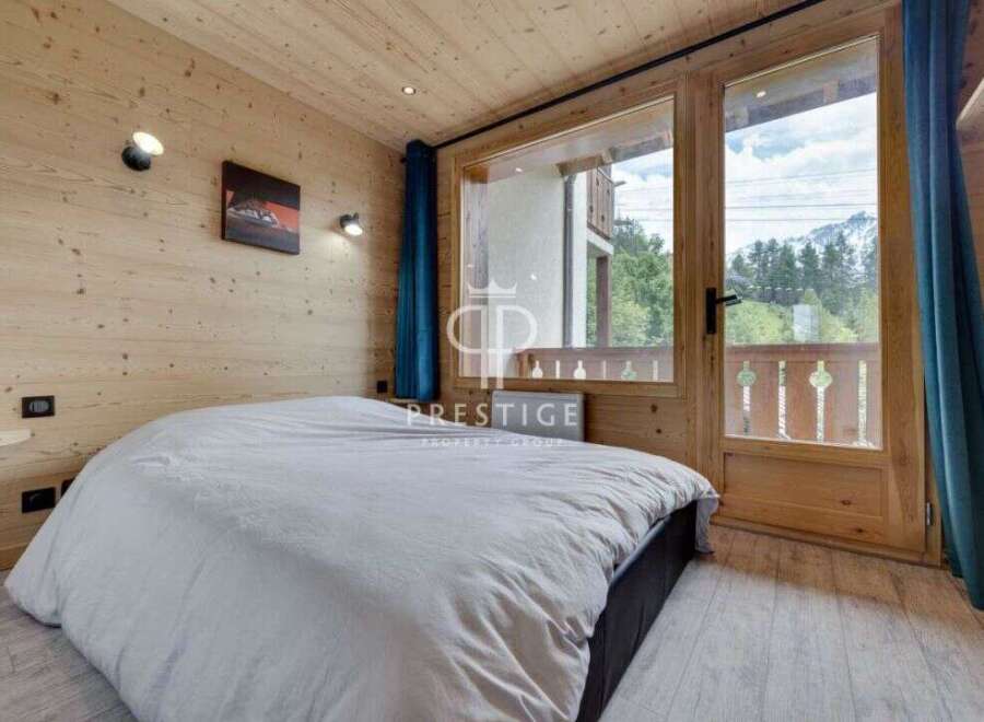 Experience the charm of this cozy bedroom, featuring warm wooden accents and a serene ambiance.