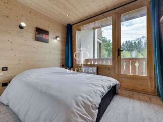 Experience the charm of this cozy bedroom, featuring warm wooden accents and a serene ambiance.