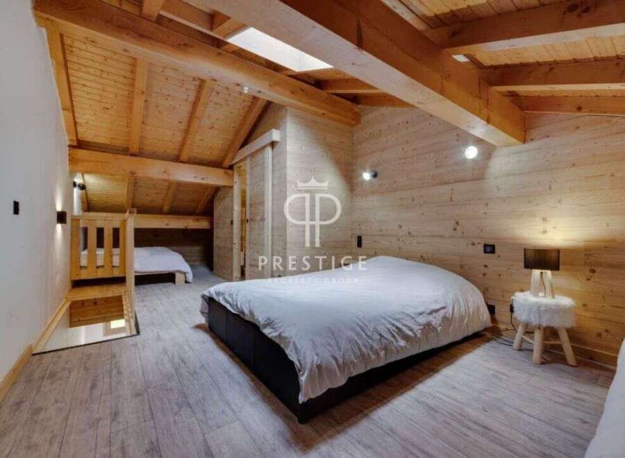 Discover the charm of this cozy bedroom, featuring a unique wooden design that exudes warmth and character.