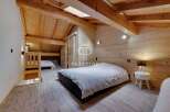 Discover the charm of this cozy bedroom, featuring a unique wooden design that exudes warmth and character.